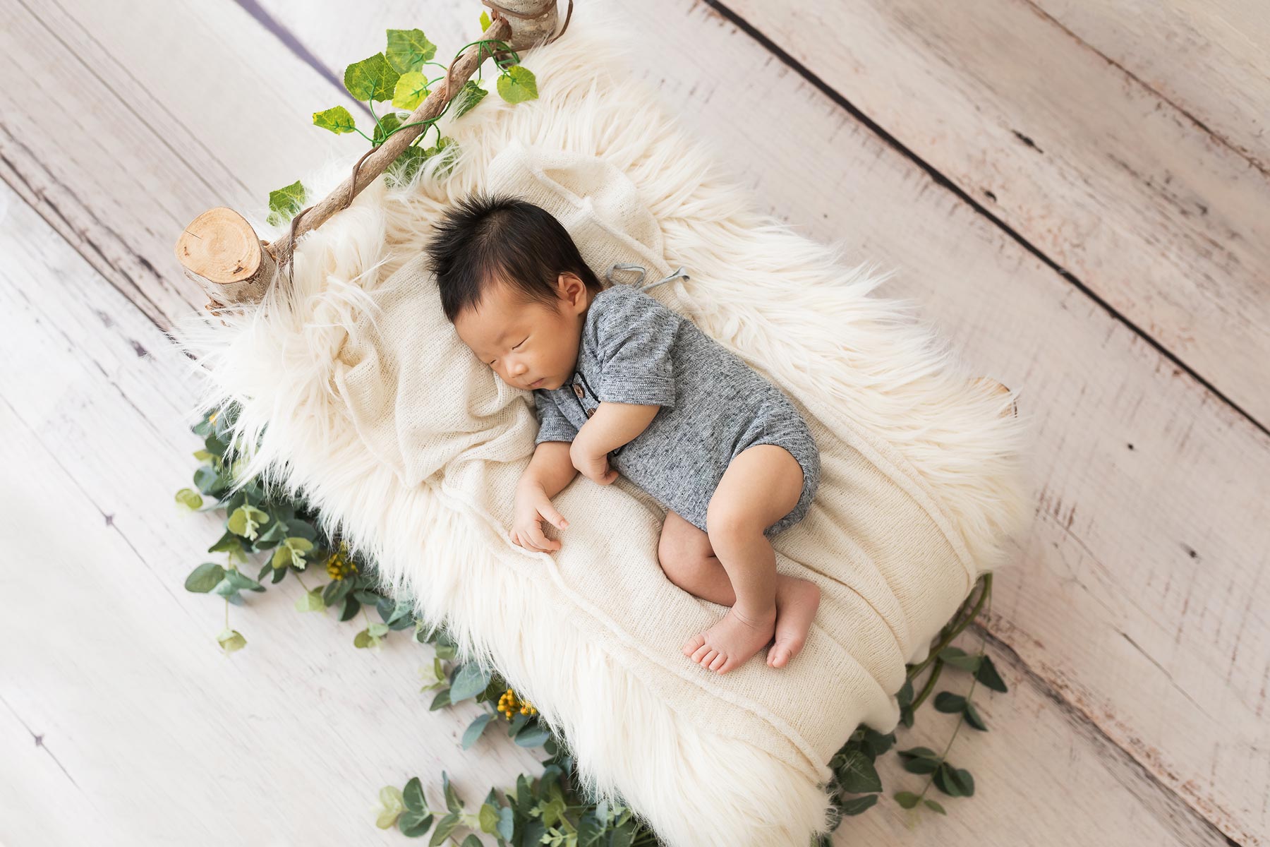 newborn photo session baby on bed sleeping.